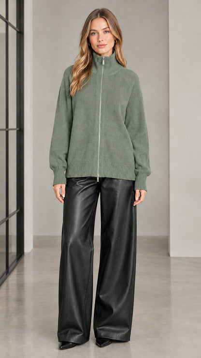 Front view of woman wearing sage green full zip high neck knit sweater