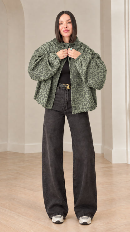 Model wearing sage green leopard print hooded jacket with wide leg denim pants