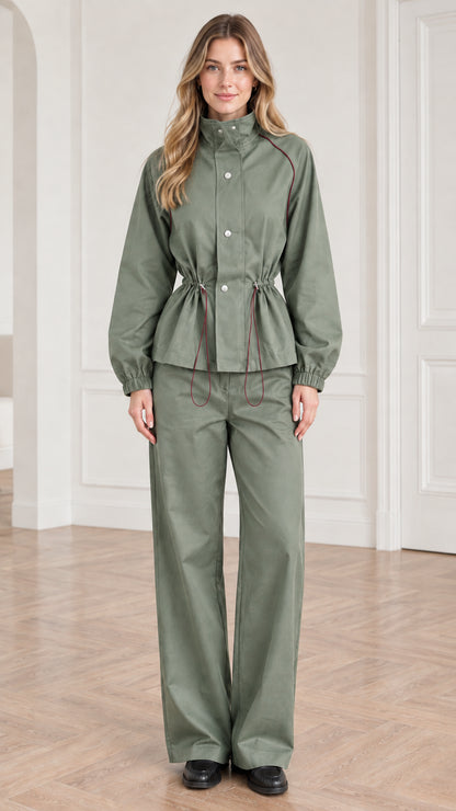 Front view of woman wearing sage green two-piece utility jacket and pant set