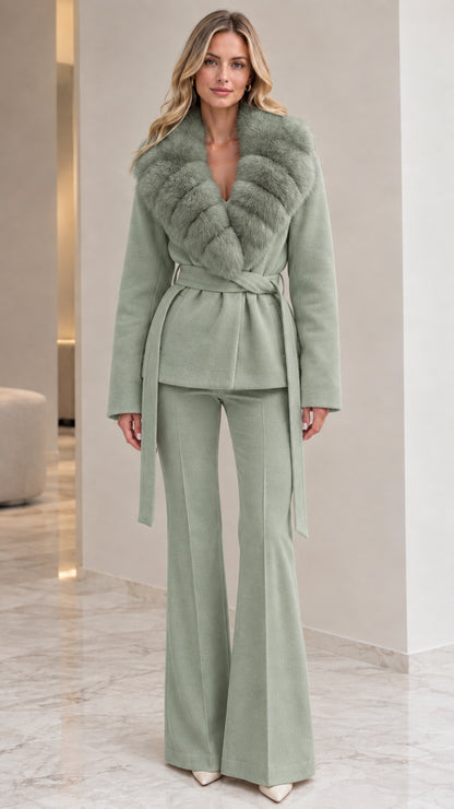 Model wearing sage green belted wrap coat with matching faux fur collar