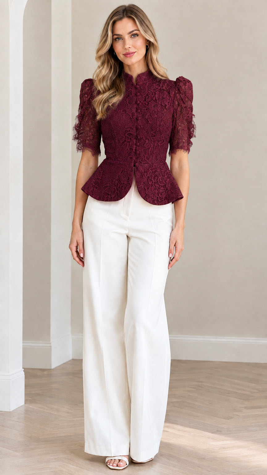 Model wearing burgundy floral lace peplum blouse with white trousers