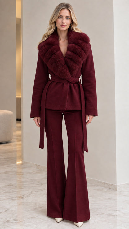 Model wearing deep burgundy belted wrap coat with rich wine faux fur collar