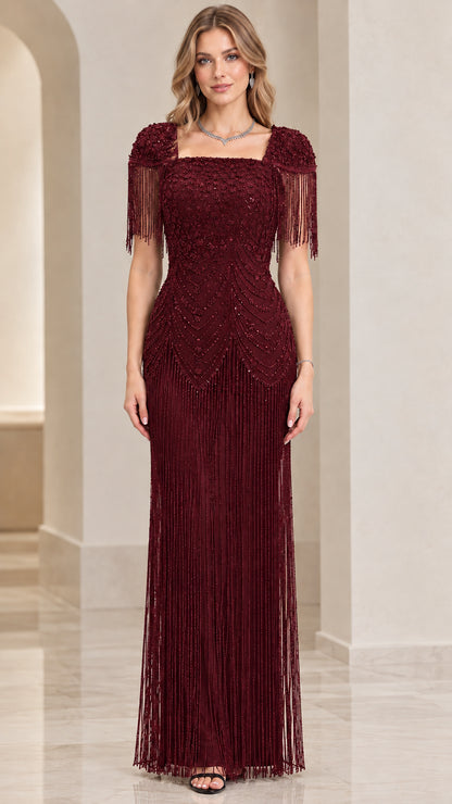 Front view of burgundy beaded maxi formal dress with shoulder fringe