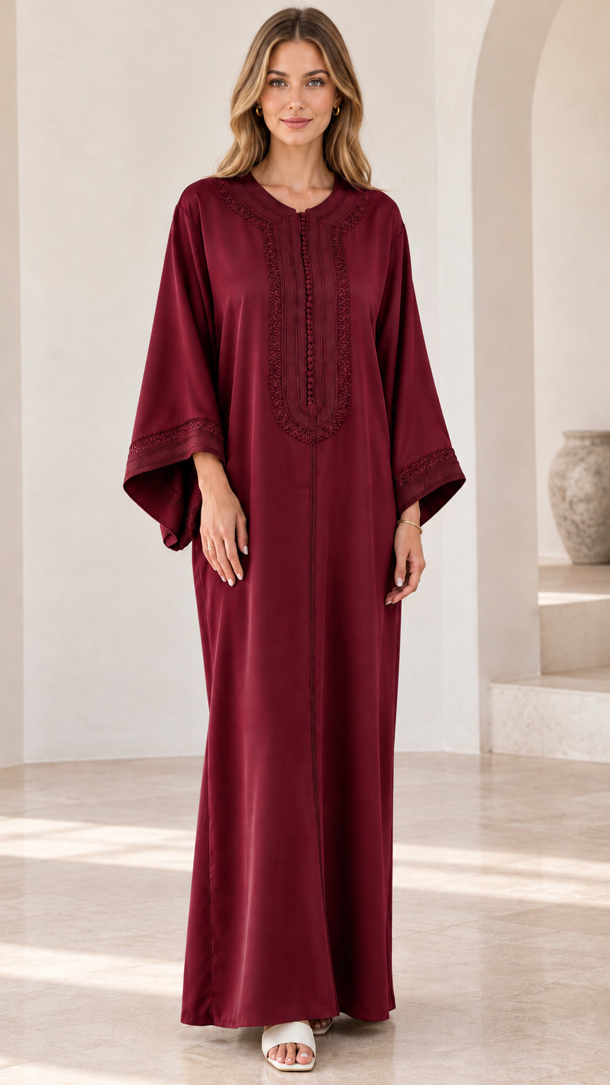 Full-length view of woman wearing burgundy embroidered kaftan maxi dress
