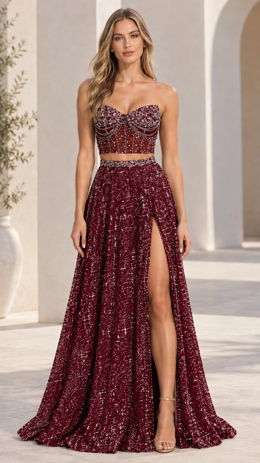 Model wearing burgundy red two-piece beaded bustier maxi formal gown
