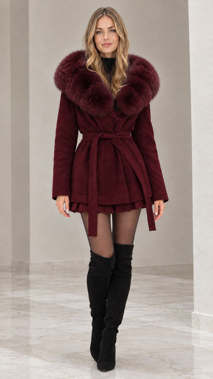Front view of model wearing burgundy wine red faux fur hooded belted coat with black boots