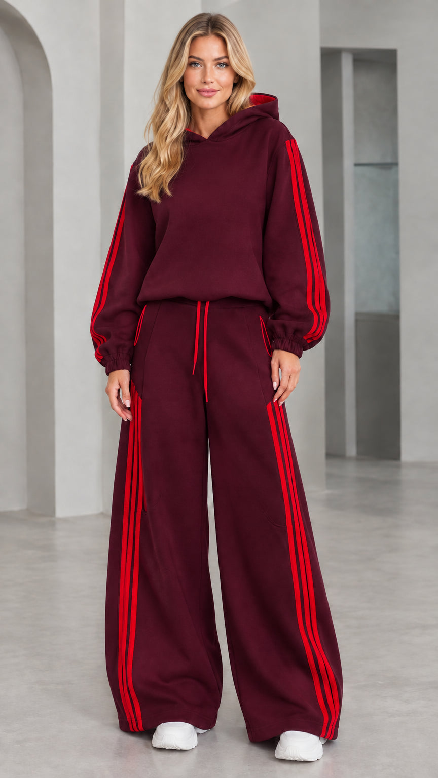 Front view of woman wearing burgundy 2-piece wide leg tracksuit set with red stripes