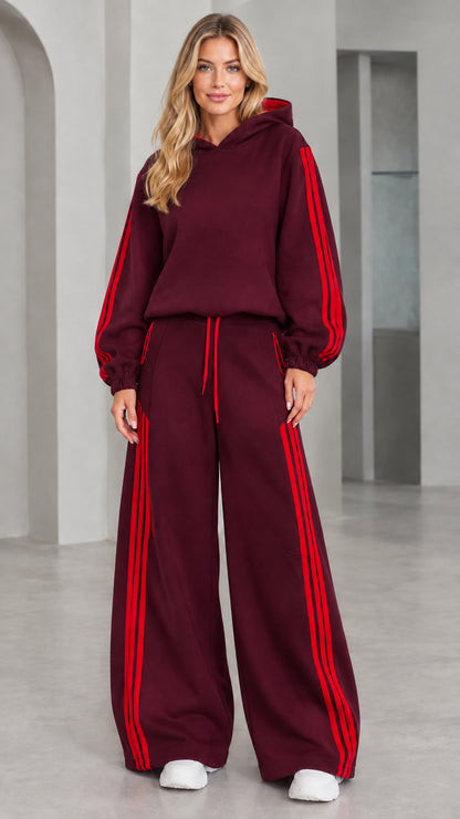 Front view of woman wearing burgundy 2-piece wide leg tracksuit set with red stripes