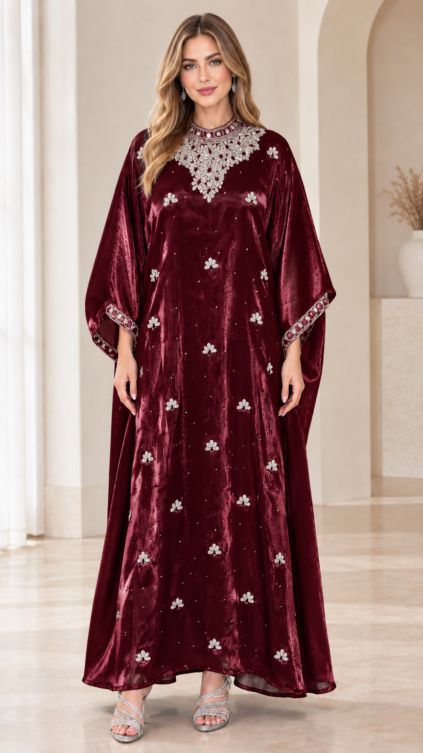 Model wearing burgundy velvet kaftan maxi dress with ornate crystal details