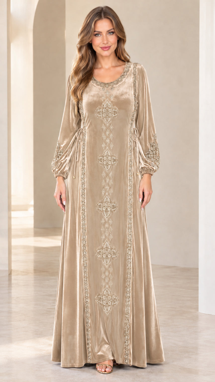 Front view of model wearing champagne beige embroidered velvet maxi dress
