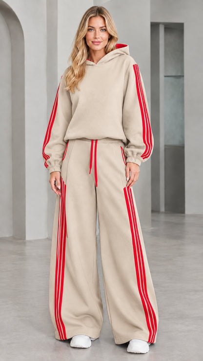 Front view of woman wearing beige 2-piece wide leg tracksuit set with red stripes