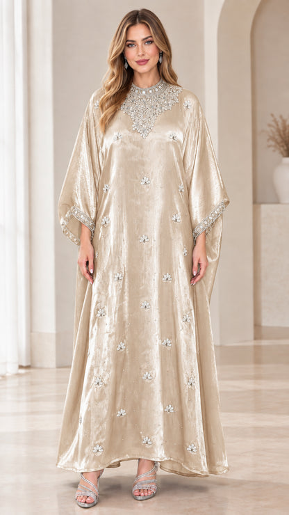 Model wearing champagne velvet kaftan maxi dress with sparkling embellishments