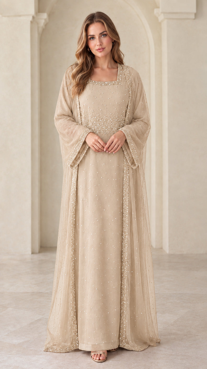 Front view of model wearing champagne beige beaded layered maxi gown