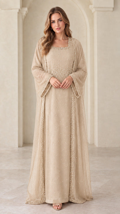 Front view of model wearing champagne beige beaded layered maxi gown
