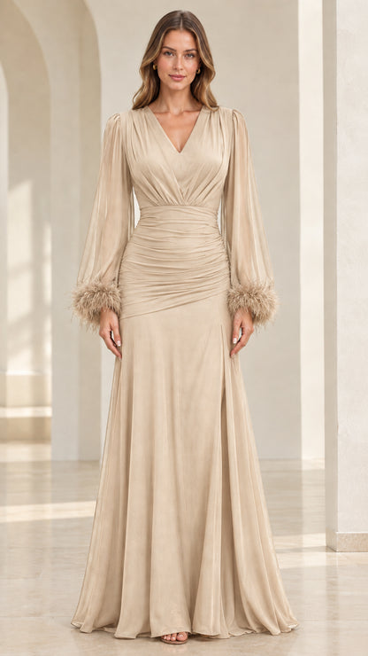 Model wearing champagne beige pleated evening maxi dress with feather cuffs