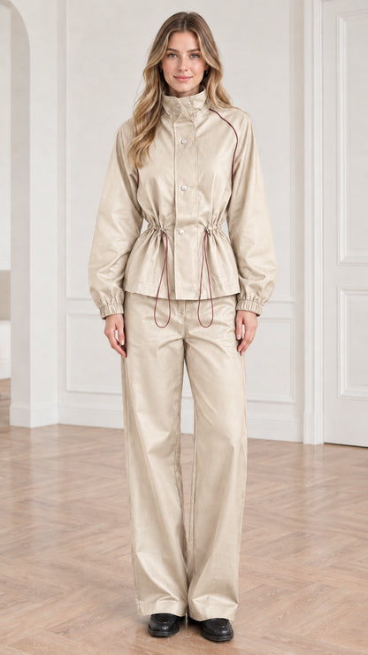 Front view of woman wearing beige cream cinched waist utility jacket and wide-leg pants