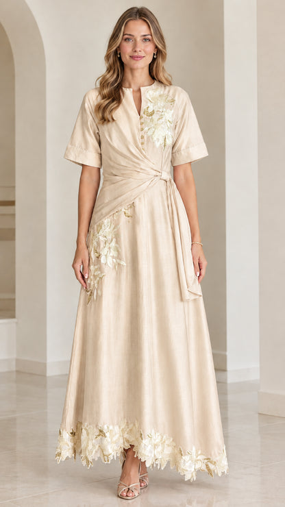 Front view of champagne floral embroidered twist-waist maxi dress