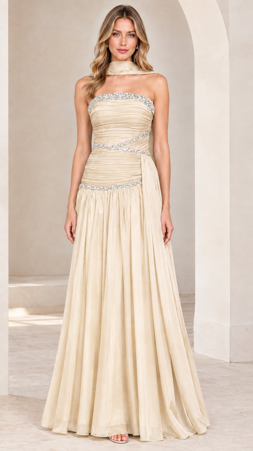 Front view of model wearing champagne strapless rhinestone ruched chiffon evening gown