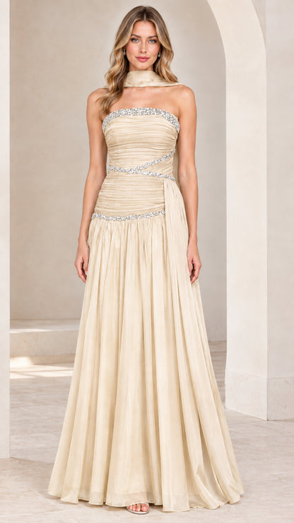 Front view of model wearing champagne strapless rhinestone ruched chiffon evening gown